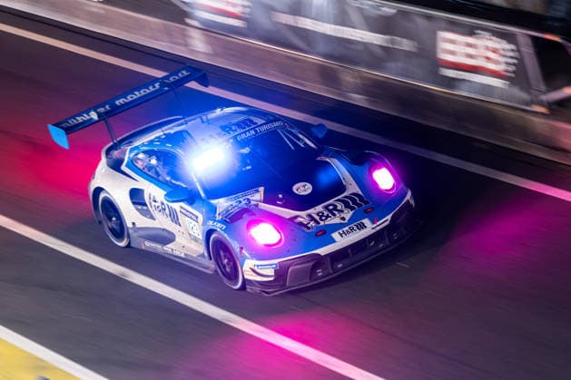 The Porsche 911 GT3 R 992 Evo26 with starting number 123 from the Mühlner Motorsport powered by H R team with drivers Martin Rump and Ben Bünnagel will be driving at night in the pit lane on the Nürburgring Grand Prix circuit in Nürburg, Rhineland-Palatinate, Germany during the 24-hour race
