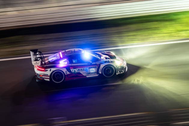 The Porsche 911 GT3 R 992 Evo26 with starting number 86 from the High Class Racing team with drivers Kerong Li, Anders Fjordbach, Hongli Ye and King Harry will be driving at night on the Nürburgring Grand Prix circuit in Nürburg, Rhineland-Palatinate, Germany during the 24-hour race