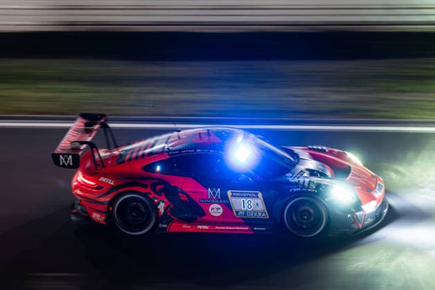The Porsche 911 GT3 R 992 Evo26 with starting number 18 from the Lionspeed GP team with drivers Kyle Tilley, Jake Hill and Patrick Kolb drives at night on the Nürburgring Grand Prix circuit in Nürburg, Rhineland-Palatinate, Germany during the 24-hour race.