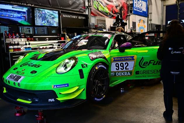 Björn Griesemann Dirk Adorf Georg Griesemann Marco Holzer Manthey Team eFuel Griesemann stands in the pit garage at the Nürburgring The striking green-painted vehicle of Manthey Team eFuel Griesemann bears the starting number 992 and is prominently adorned with sponsors such as RAVENOL, LeFuels, Griesemann and H R prominently displayed in the background are monitors, tools and other pit equipment The car is positioned on red stands while team members work in the pits Porsche 911 GT3 R 992 from Manthey Team eFuel Griesemann in the pits Copyright: xMichaelxGelhardtx