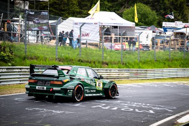 The striking green car with the starting number 63 from HWA Engineering Speed drives through a corner on the Nürburgring Nordschleife The dark green racing car bears eye-catching sponsors such as Parkside, Hankook, H R and Composite Impulse and is equipped with a large rear wing Spectators, tents and advertising banners can be seen in the background along the track barrier Adam Adelson James Green Lance David Arnold Renger Van der Zande HWA Engineering Speed HWA 63 Parkside car on the Nürburgring Nordschleife Copyright: xMichaelxGelhardtx