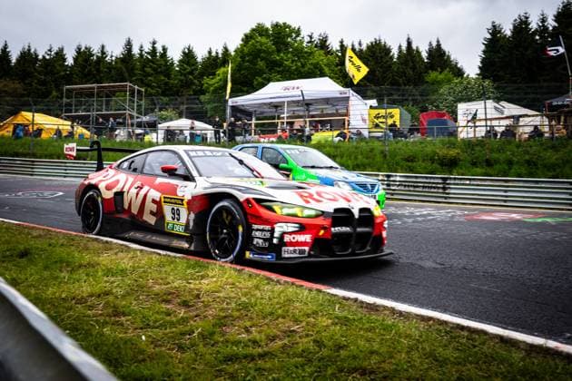 Dan Harper Dries Vanthoor Max Hesse Sheldon van der Linde ROWE RACINGs Dan Harper Dries Vanthoor Max Hesse Sheldon van der Linde ROWE RACING drives through a corner on the Nordschleife at the Nürburgring The car in the striking red and white ROWE livery bears the starting number 99 and shows sponsors such as RAVENOL, ENDLESS and H R Another car in blue and green livery can be seen in the background, while numerous spectators watch the action on the side of the track BMW M4 GT3 99 from ROWE RACING on the Nordschleife Copyright: xMichaelxGelhardtx
