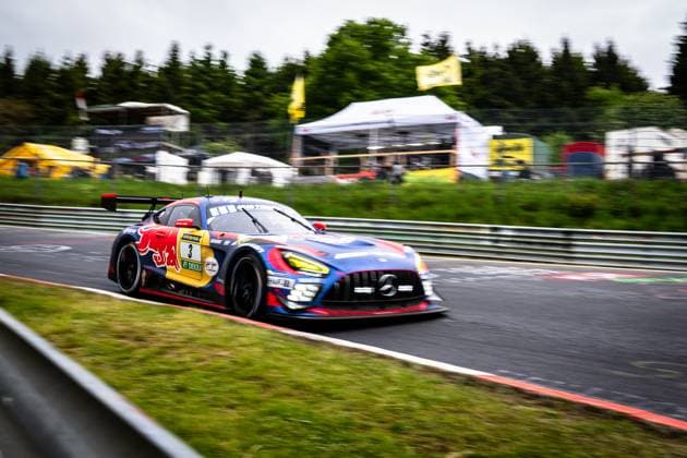 The Mercedes AMG GT3 from Mercedes AMG Team Verstappen Racing drives through a corner at high speed on the Nürburgring The vehicle Daniel Juncadella Jules Gounon Lucas Auer Max Verstappen Mercedes AMG Team Verstappen Racing wears a striking Red Bull livery in blue, red and yellow and features the sponsors RAVENOL and DEKRA The motion blur in the background emphasizes the high speed of the vehicle on the race track Mercedes AMG GT3 3 from Verstappen Racing at the Nürburgring Copyright: xMichaelxGelhardtx
