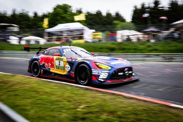 The Mercedes AMG GT3 with starting number 3 from Mercedes AMG Team Verstappen Racing drives through a corner at high speed on the Nürburgring The vehicle wears the striking Red Bull livery in blue, red and yellow with RAVENOL and DEKRA sponsorship The panning shot emphasizes the dynamics of the racing car, while the background blurs with pits and trees Daniel Juncadella Jules Gounon Lucas Auer Max Verstappen Mercedes AMG Team Verstappen Racing Mercedes AMG GT3 3 from Verstappen Racing at the Nürburgring Copyright: xMichaelxGelhardtx
