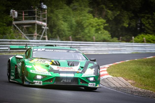 The Lamborghini Huracán GT3 Marco Mapelli Nicholas Yelloly Nicky Catsburg Red Bull Team ABT by Red Bull Team ABT takes a fast corner on the Nordschleife of the Nürburgring The green-painted car with starting number 130 is adorned with sponsors such as Schaeffler, SONAX, H R and Gran Turismo The front headlights shine brightly as the car is steered precisely over the asphalt Lamborghini Huracán GT3 130 by Red Bull Team ABT on the Nordschleife Copyright: xMichaelxGelhardtx