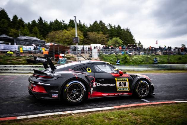 The Porsche 911 GT3 of BLACK FALCON Team ZIMMERMANN Alexander Hardt Bear Benjamin Hites Benjamin Koslowski Paul Meijer BLACK FALCON Team ZIMMERMANN drives through a corner on the Nürburgring at the ADAC RAVENOL 24h Nürburgring 2026 The black and red car with the starting number 900 carries prominent sponsors such as Zimmermann, RAVENOL, Fanatec and LIQUI MOLY on the bodywork In the background, numerous spectators can be seen at the trackside Porsche 911 GT3 900 from BLACK FALCON Team ZIMMERMANN at the Nürburgring Copyright: xMichaelxGelhardtx