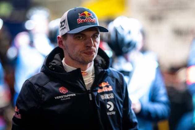 Max Verstappen can be seen in the paddock of the Nürburgring He is wearing the dark blue team jacket of Mercedes AMG Team Verstappen Racing with Red Bull and Viaplay sponsorship as well as a Red Bull cap In the background, other people in team clothing can be seen Max Verstappen in the paddock at the 24h Nürburgring 2026 Copyright: xMichaelxGelhardtx