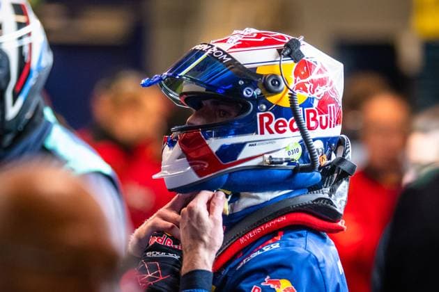 Driver with Red Bull helmet and blue racing overall prepares in the paddock Driver with Red Bull helmet in the paddock Copyright: xMichaelxGelhardtx