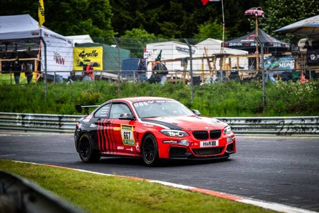 Aidan Mulready Alvaro Fontes Andreas Simon James Breakell Breakell Racing from Breakell Racing takes a corner exit on the Nordschleife of the Nürburgring The red and black painted BMW M240i Racing Coupé with starting number 667 presents itself with sponsors such as RAVENOL, Falken, Goodyear and H R Spectator areas, advertising banners and the characteristic green of the Eifel landscape can be seen in the background BMW M240i Racing 667 from Breakell Racing on the Nordschleife Copyright: xMichaelxGelhardtx