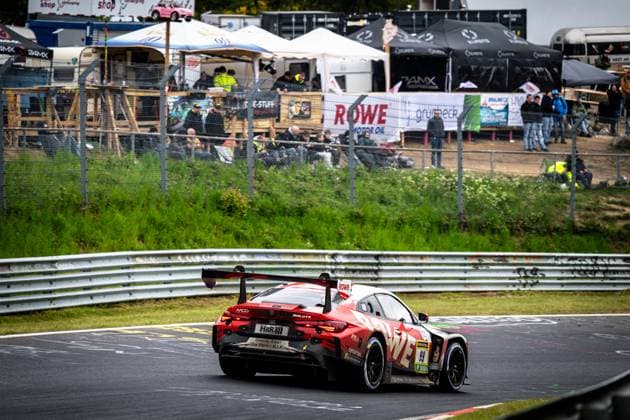 The Dan Harper Dries Vanthoor Max Hesse Sheldon van der Linde ROWE RACING BMW M4 GT3 from ROWE RACING drives through a fast corner on the Nürburgring at the ADAC RAVENOL 24h Nürburgring 2026 The red and black painted car with the starting number 99 and prominent ROWE sponsorship can be seen from behind, the large rear wing and the MCG lettering on the rear are clearly recognizable In the background, numerous spectators line the track BMW M4 GT3 99 from ROWE RACING at the Nürburgring, which is decorated with advertising banners from ROWE Motor Oil and Grünbeck Copyright: xMichaelxGelhardtx