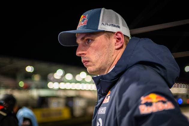 Close-up of a driver in the paddock of the Nürburgring with Red Bull team clothing and cap In the background you can see the pits and hospitality areas of the race venue Max Verstappen in the paddock at the 24h Nürburgring 2026 Copyright: xMichaelxGelhardtx