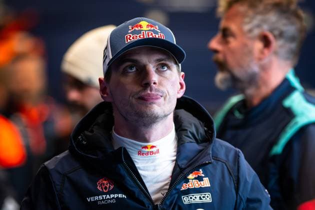 Portrait of a racing driver in Red Bull teamwear with cap and black jacket in the Nürburgring paddock Other people and team tents are visible in the background Max Verstappen in Red Bull teamwear at the Nürburgring Copyright: xMichaelxGelhardtx