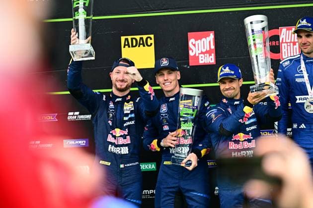 Luca Engstler and Mirko Bortolotti from Red Bull Team ABT proudly present their trophy on the podium The team in the classic dark blue racing suits with Red Bull sponsorship triumphs in the 24-hour race on the legendary Nordschleife Red Bull Team ABT celebrates podium success at the Nürburgring Copyright: xMichaelxGelhardtx