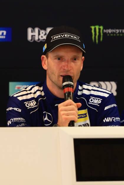 Maro Engel speaks at a press conference in the paddock of the 24h Nürburgring The driver of Mercedes AMG Team RAVENOL wears the characteristic dark blue team clothing with OMP and RAVENOL branding Maro Engel at the press conference of Mercedes AMG Team RAVENOL Copyright: xspeedshotx