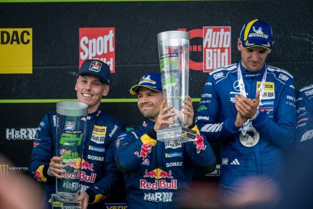 The winning teams present their trophies on the podium of the 24h Nürburgring 2026 Red Bull Team ABT with the BMW M4 GT3 84 and Mercedes AMG Team RAVENOL with the Mercedes AMG GT3 80 dominate the endurance race on the Nordschleife Red Bull Team ABT and Mercedes AMG Team RAVENOL celebrate 24h Nürburgring victory 2026 Copyright: xMichaelxGelhardtx
