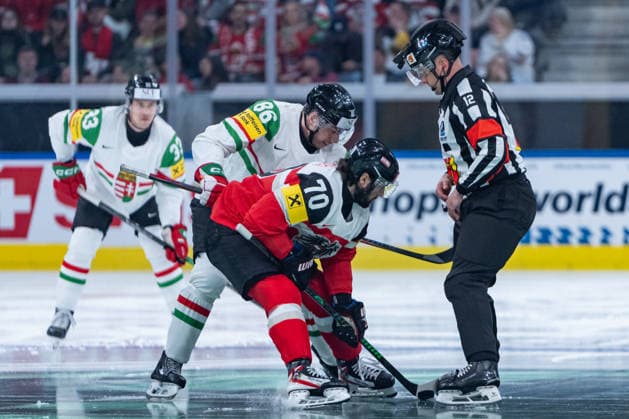 ZURICH, SWITZERLAND - MAY 17: Jiri Indracek (Referee) opining the game, Benjamin Nissner (Austria, 70) in the battle for the puck with Balazs Seboek (Hungary, 86) during the Preliminary Round - Group A Match 13 between Austria and Hungary at the IIHF Ice hockey, Eishockey World Championship, WM, Weltmeisterschaft 2026, Swiss Life Arena on May 17, 2026 in Zurich, Switzerland. Zurich Switzerland Copyright: xTimoxSteinx
