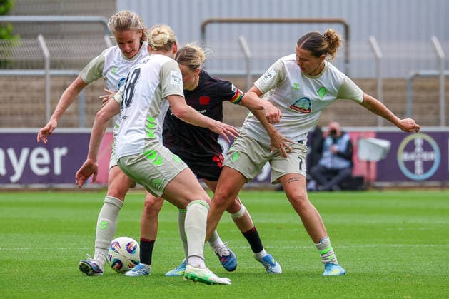 17 05 2026, xsscx, Women Soccer, Bayer 04 Leverkusen Werder Bremen, 1 Soccer Bundesliga, 26 Matchday, Ulrich Haberland Stadium, Season 2025 2026 Lina Hausicke Werder Bremen 18 in duel against Kristin Kögel Bayer Leverkusen 11 and Larissa Mühlhaus Werder Bremen 7 DFB regulations prohibit any use of photographs as image sequences and or quasi video Photo xSandraxScherningxPressefotoKochx Nordrhein Westfalen Germany