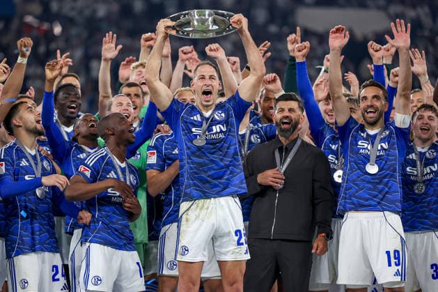 17 05 2026, Football, FC Schalke 04 Eintracht Braunschweig, Matchday 34, Bundesliga 2, Veltins Arena Gelsenkirchen, Season 2025 2026 Schalke 04 is champion of the 2 Bundesliga The team wins the championship and stands cheering on the pitch Joy and emotions after the victory Handover of the award ceremony Nikola Katic Schalke04 25 with the championship trophy in his hand next to head coach Miron Muslic Schalke04 on the podium DFB regulations prohibit any use of photographs as image sequences and or quasi video North Rhine-Westphalia Germany