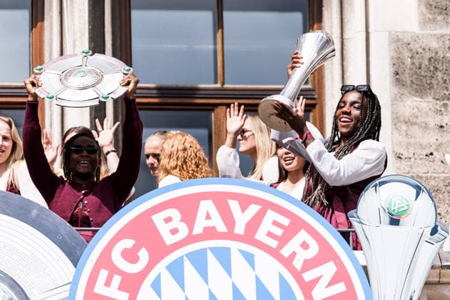 MUNICH, GERMANY - MAY 18: Kakounan Bernadette Amani (FC Bayern Muenchen, 15) holding up the Google Pixel Frauen Bundesliga trophy, Edna Imade (FC Bayern Muenchen, 29) holding up the DFB Pokal during the Meisterfeier of FC Bayern Muenchen women at Marienplatz on May 18, 2026 in Munich, Germany. Bavaria Germany Copyright: xSteffiexWunderlx