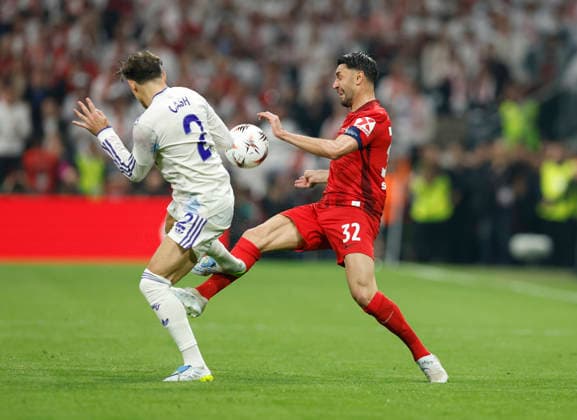 Istanbul, Turkey, 20th May 2026. Matty Cash of Aston Villa catches Vincenzo Grifo of SC Freiburg in the leg for which he receives a yellow card during the SC Freiburg vs Aston Villa UEFA Europa League Final match at Besiktas Park, Istanbul. Picture credit should read: Cody Froggatt Sportimage EDITORIAL USE ONLY. No use with unauthorised audio, video, data, fixture lists, club league logos or live services. Online in-match use limited to 120 images, no video emulation. No use in betting, games or single club league player publications. SPI_064_CF_Frieburg_Aston_Villa SPI-4796-0094