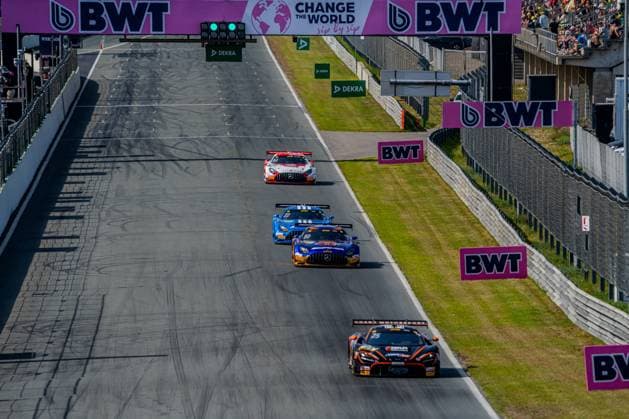 The McLaren 720S GT3 Evo of Ben Dörr 25, Dörr Motorsport leads a group of three on the starting straight of the Circuit Zandvoort under the BWT bridge with green traffic light signal Behind them follow the Mercedes AMG GT3 80 of Maro Engel Mercedes AMG Team Winward as well as another blue Mercedes AMG GT3 and a white car McLaren 720S GT3 Evo 25 of Ben Dörr Dörr Motorsport leads group at Circuit Zandvoort Copyright: xMichaelxSchäferx