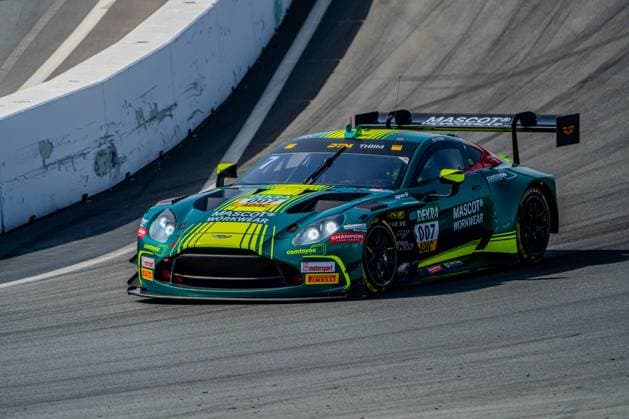 The Aston Martin Vantage GT3 7 of Nicki Thiim Comtoyou Racing drives through a fast corner at Circuit Zandvoort The vehicle in teal jade blue and neon yellow with characteristic stripe pattern shows the racing livery of Comtoyou Racing with the sponsors Mascot, Champion and Dewiba Aston Martin Vantage GT3 7 of Nicki Thiim Comtoyou Racing at Circuit Zandvoort Copyright: xMichaelxSchäferx