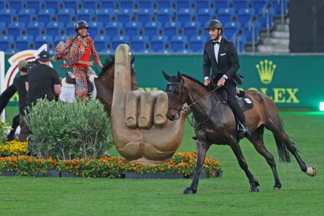 Richard Vogel in a tuxedo through the Aachen Soers and at the Öcher Klenkes obstacle and finger pointing, greeting from the Aacheners, Richard Vogel and Luciana Diniz at speed together in Bond Stunt Feeling over the obstacles, concert horse symphony, supporting program, motto of the evening James Bond, World Equestrian Festival, TSCHIO Aachen 2026, TSCHIO instead of CHIO 2026, Aachen Soers, 22 to 24 May 2026, equestrian sport, 23 05 2026, Aachen Soers Germany