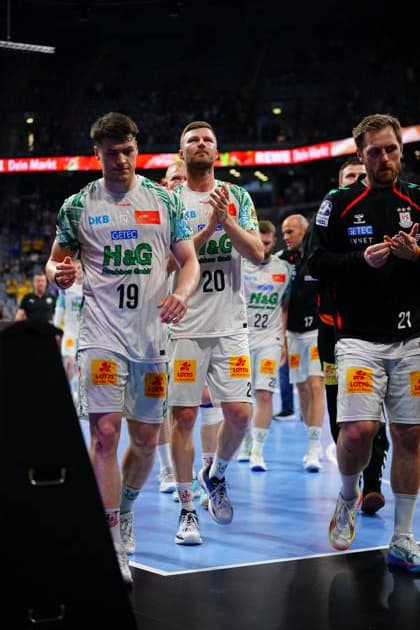 Philipp Weber 20 and Albin Lagergren 21 of SC Magdeburg run off the SAP Arena pitch together in white jerseys Other Magdeburg players, including 19 Elvar Örn Jonsson, follow the team into the dressing room Philipp Weber 20 SC Magdeburg and Albin Lagergren 21 SC Magdeburg leave the pitch Copyright: xspeedshotx