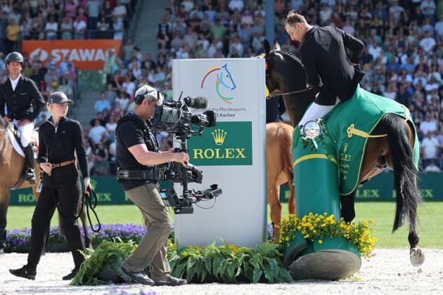 Winner, 1 place, Richard Vogel GER with horse United Touch S, Rolex Grand Slam of Show Jumping, Award ceremony, On the way to the Grand Slam, United Touch S and Richi lift the trophy from the pedestal, Funny Moment, Jumping competition with two rounds and jump-off, World Equestrian Festival, World Equestrian Festival, TSCHIO Aachen 2026, TSCHIO instead of CHIO 2026, Aachener Soers, 22 to 24 May 2026, Equestrian sport, 24 05 2026, Aachen Aachener Soers Germany