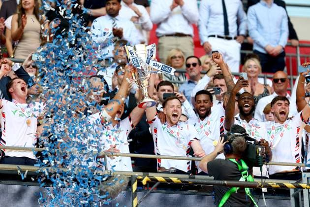 George Johnston of Bolton Wanderers celebrates with the trophy after winning the Sky Bet EFL League One Play-off Final and promotion to the Sky Bet EFL Championship Bolton Wanderers v Stockport County, EFL Sky Bet League One, Play-Off Final, Football, Wembley Stadium, London, UK - 24 May 2026London Wembley Stadium United Kingdom EDITORIAL USE ONLY No use with unauthorised audio, video, data, fixture lists, club league logos or live services. Online in-match use limited to 120 images, no video emulation. No use in betting, games or single club league player publications.  Copyright: xSimonxDael Shutterstockx 16889811gi