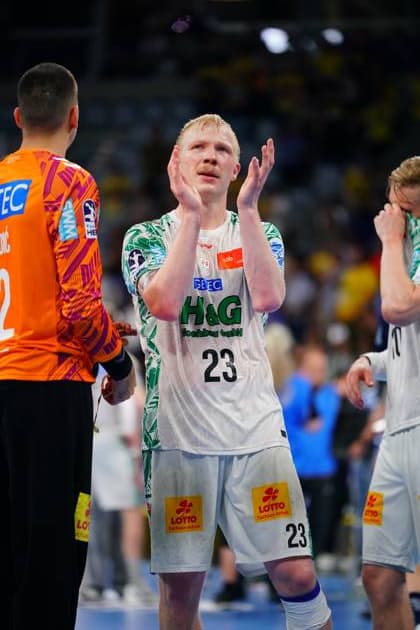 Magnus Saugstrup 23 of SC Magdeburg applauds after the match in the SAP Arena, goalkeeper Matej Mandi stands on the left in the orange goalkeeper jersey Another Magdeburg player in the white jersey can be seen in the background Magnus Saugstrup 23 SC Magdeburg applauds after the match Copyright: xspeedshotx