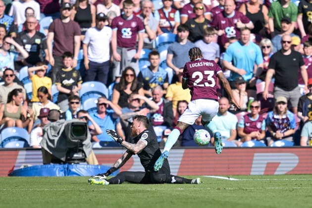 24th May 2026; Turf Moor, Burnley, Lancashire, England; Premier League Football, Burnley versus Wolverhampton Wanderers; Lucas Pires of Burnley jumps over Jose Sa of Wolverhampton Wanderers during his run towards the goal LeexDurkin