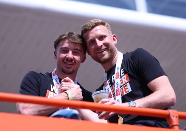 Hull Bus Parade Charlie Hughes of Hull City (left) and Hull City goalkeeper Dillon Phillips on one of the buses outside the MKM Stadium before the Hull City Bus Parade on the streets of Hull, England after being promoted to the Premier League in the Sky Bet Championship Play-Off Final on Saturday 23rd May 2026. 25 05 2026 UK Newspapers OUT Copyright: xAndyxSumnerx FIL-23472-0066