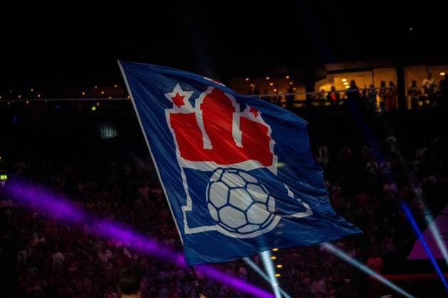 The flag of the Handball Sport Verein Hamburg flies in front of spectators in the illuminated Barclays Arena The banner shows the clubs logo with handball and Canadian flag motif against a dark background HSV Hamburg flag in the Barclays Arena Copyright: xPhilippHeistx
