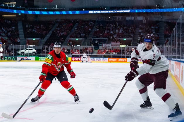 ZURICH, SWITZERLAND - MAY 26: Csanad Erdely (Hungary, 36) in the battle for the puck with Artus Andzans (Latvia, 5) during the Preliminary Round - Group A Match 51 between Hungary and Latvia at the IIHF Ice hockey, Eishockey World Championship, WM, Weltmeisterschaft 2026, Swiss Life Arena on May 26, 2026 in Zurich, Switzerland. Zurich Switzerland Copyright: xTimoxSteinx