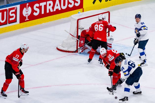 ZURICH, SWITZERLAND - MAY 26: Tim Berni (Switzerland, 56) securing the puck from Mikael Granlund (Finland, 64) during the Preliminary Round - Group A Match 55 between Switzerland and Finland at the IIHF Ice hockey, Eishockey World Championship, WM, Weltmeisterschaft 2026, Swiss Life Arena on May 26, 2026 in Zurich, Switzerland. Zurich Switzerland Copyright: xTimoxSteinx