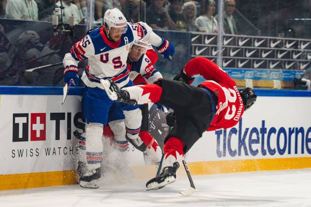 FRIBOURG, FRIBOURG - MAY 28: Evan Bouchard of Canada is checked by Ryan Lindgren of the United States during the 2026 IIHF World Championship, WM, Weltmeisterschaft quarterfinal match between Canada and the United States at BCF Arena on May 28, 2026 in Fribourg, Fribourg, Switzerland. Copyright: xLivioxBaeriswylx xSPPx Sportspressphoto_SPR156126