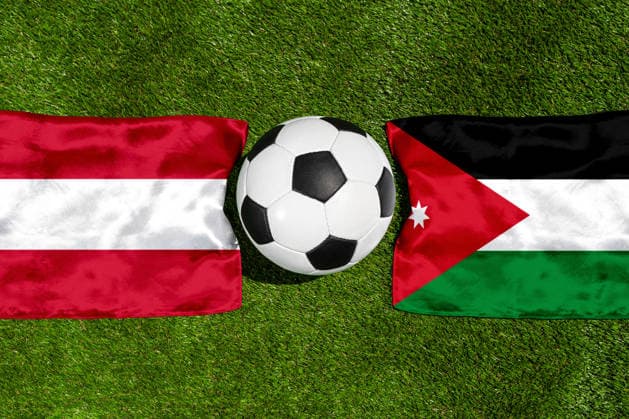 FOTOMONTAGE, Fußball-Weltmeisterschaft 2026: Nationalflaggen von Österreich und Jordanien mit Fußball auf Rasen. Symbolbild zum WM-Gruppenspiel am 17 Juni bei der FIFA Fussball-Weltmeisterschaft 2026