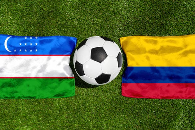 FOTOMONTAGE, Fußball-Weltmeisterschaft 2026: Nationalflaggen von Usbekistan und Kolumbien mit Fußball auf Rasen. Symbolbild zum WM-Gruppenspiel am 18 Juni bei der FIFA Fussball-Weltmeisterschaft 2026