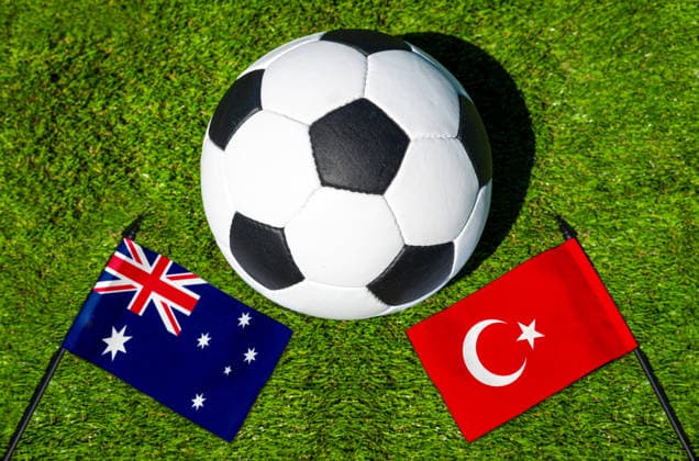 FOTOMONTAGE, Fußball-Weltmeisterschaft 2026: Nationalflaggen von Australien und Türkei mit Fußball auf Rasen. Symbolbild zum WM-Gruppenspiel am 14 Juni bei der FIFA Fussball-Weltmeisterschaft 2026