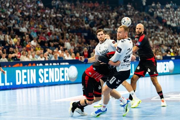 Kent Robin Tonnesen 23 SG Flensburg Handewitt fights with the ball through the defense of MT Melsungen, while Johannes Golla 3 SG Flensburg Handewitt and Adrián Sipos 8 MT Melsungen can be seen in the background MT player 25 Olle Forsell Schefvert tries to stop the attack MT Melsungen vs SG Flensburg Handewitt - EHF Finals Hamburg 2026 Copyright: xPhilippHeistx