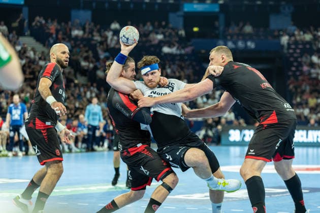 Goalkeeper Kristof Palasics MT Melsungen , Johannes Golla SG Flensburg Handewitt and Dainis Kristopans MT Melsungen battle for the ball during the handball semi final of the Winamax EHF Finals 2026 between MT Melsungen and SG Flensburg Handewitt at Barclays Arena on May 30, 2026 in Hamburg, Germany