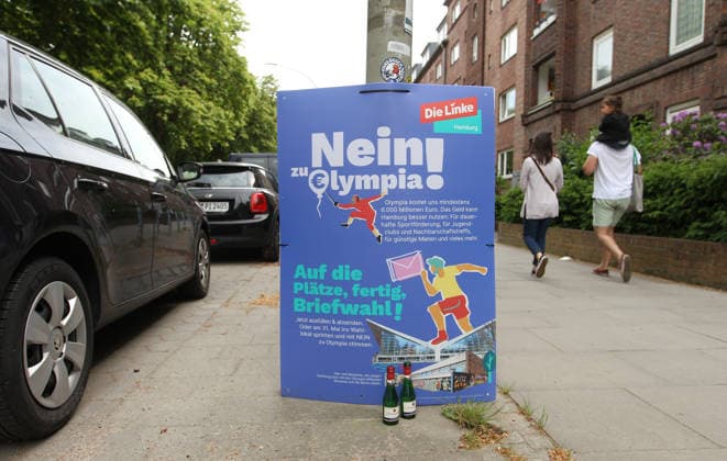 Two Piccolo bottles stand in front of a poster of the Left Party, with which it positions itself against Hamburgs bid to host the Olympic Games and Paralympics and calls on people to vote no in the referendum on May 31 Barmbek Hamburg
