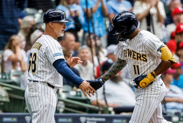 Milwaukee Brewers left fielder Jackson Chourio (R) and Milwaukee Brewers third base coach Matt Erickson (L) celebrate after Churio hit a home run in the first inning of the MLB, Baseball Herren, USA game between the Philadelphia Phillies and the Milwaukee Brewers at American Family Field in Milwaukee, Wisconsin on Sunday, June 14, 2026.  MIL20260614809 TANNENxMAURY