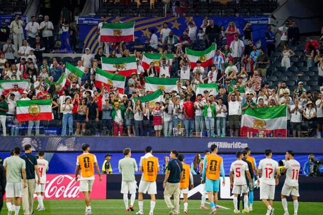 USA Soccer 2026 FIFA World Cup Group Stage Group G Iran vs. New Zealand SoFi Stadium, Inglewood, Los Angeles County, California Iranian fans celebrate their team after the match, with many displaying the historic Lion and Sun flag The pre-revolutionary flag is considered a symbol of the Iranian opposition and is used by many Iranians in exile The motif represents fan culture, the Iranian diaspora, political identity, and solidarity in the context of the 2026 FIFA World Cup,detected_source_language Copyright: xJOERANxSTEINSIEKx