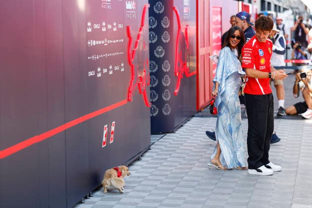 2026 Hungarian F1 Grand Prix in Budapest on July 24, 2026; Photo by Hoch Zwei, 16 LECLERC Charles mco, Scuderia Ferrari with his wife Alexandra Leclerc (Alexandra Saint Mleux) and their dog doing its business in front of the Red Bull garage; wife, dog, Budapest, Hungary