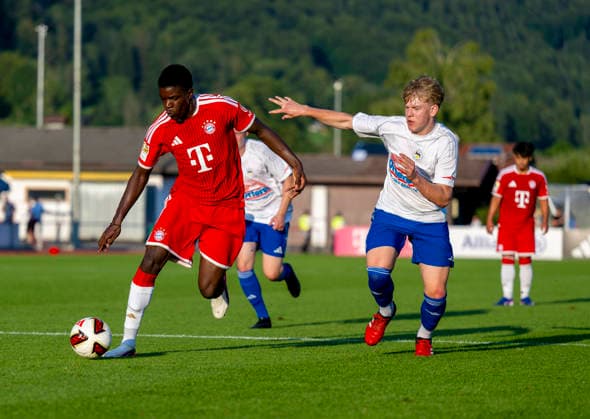 July 30, 2026, 2026–2027 Bundesliga, FC Bayern Munich training camp in Rottach Egern on Lake Tegernsee, Bavaria; friendly match between FC Rottach Egern and FC Bayern Munich; Bastian Assomo (left); FC Bayern Munich in a tackle