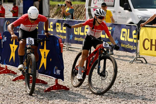 July 31, 2026, Monteceneri, Monte Ceneri, 2026 UEC MTB European Championship XCR Team Relay Final—cross-country team relay: Azize Bekar 8C TUR, Elite Women; Eren Gecim 8D TUR, Junior Men; Monteceneri, Monte Ceneri, Ticino, Switzerland Copyright: xJustPictures.ch FrancescoxMinghettix jp-en-FrMi-_NG_0688