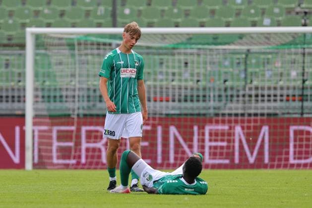 August 26, 2026, Germany, Regionalliga Nord, Soccer, Matchday 1, 2026–2027 Season, Dietmar Scholze Stadium at the Lohmuehle, VfB Lübeck vs. SC Weiche Flensburg; Final Score: 1–1; Henry Jeschonek (VfB Lübeck, No. 02) and Emmanuel Appiah (VfB Lübeck, No. 18) lying on the ground; Photo: nordphoto GmbH, Tauchnitz, Lübeck, Dietmar Scholze Stadium an der Lohmühle, SH Germany Copyright: xnordphotoxGmbHx xTauchnitzx