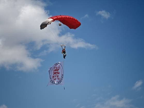 August 1, 2026 xkhx Kassel Regional League Southwest 2026–2027 Season Bundesliga Friendly Match KSV Hessen Kassel vs. FC Schalke 04: The Kassel flag is carried into the stadium on a red-and-white paraglider